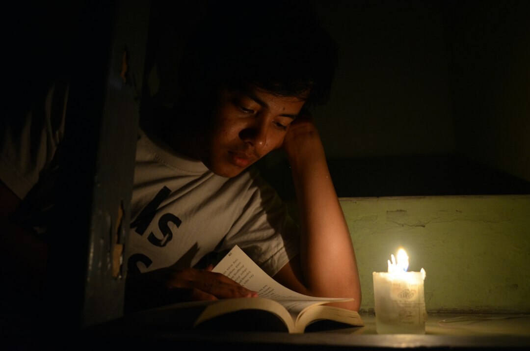 person reading book at night